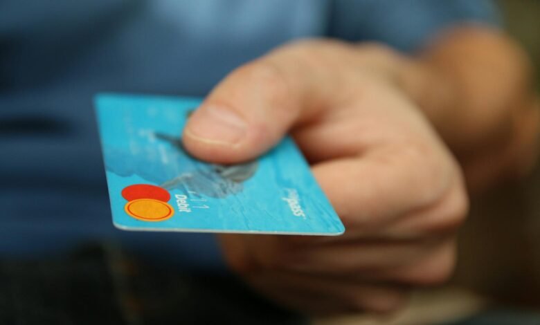 person holding debit card