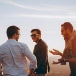 three men standing while laughing