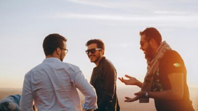 three men standing while laughing