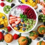 assorted sliced fruits in white ceramic bowl