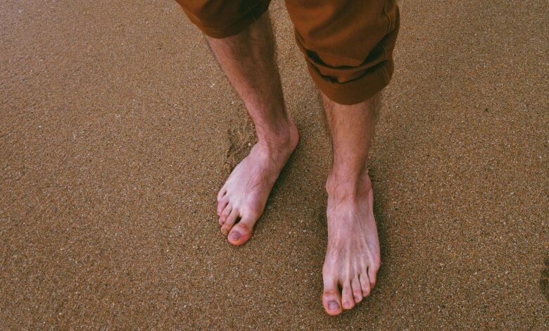 close up photo of person standing on seashore