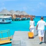 man and woman walks on dock