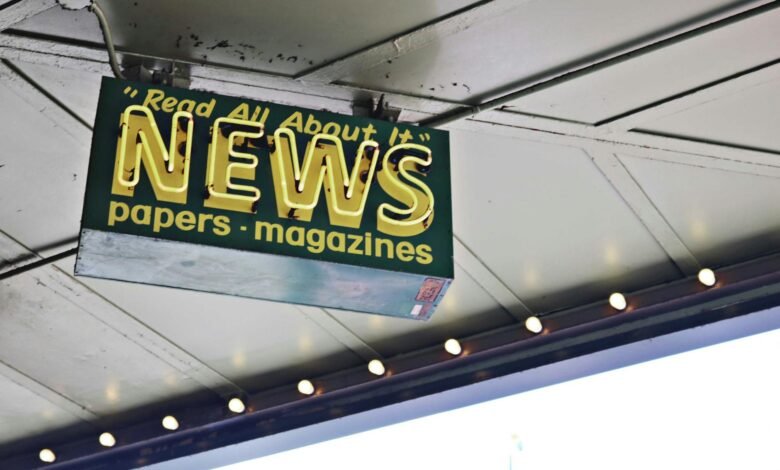 news inscription on neon signboard hanging on street