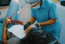 a woman getting her teeth checked by a dentist