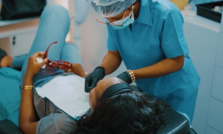 a woman getting her teeth checked by a dentist