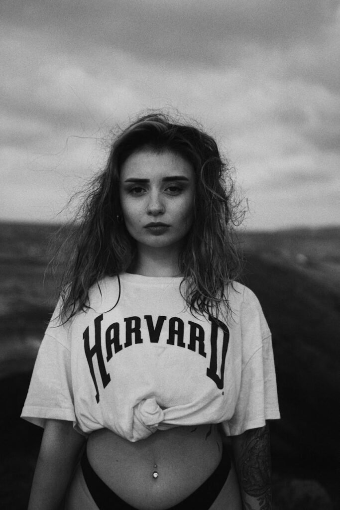 young girl on the beach in a harvard t shirt