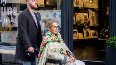 man pushing elderly lady on a wheelchair