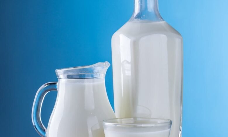 close up of milk against blue background