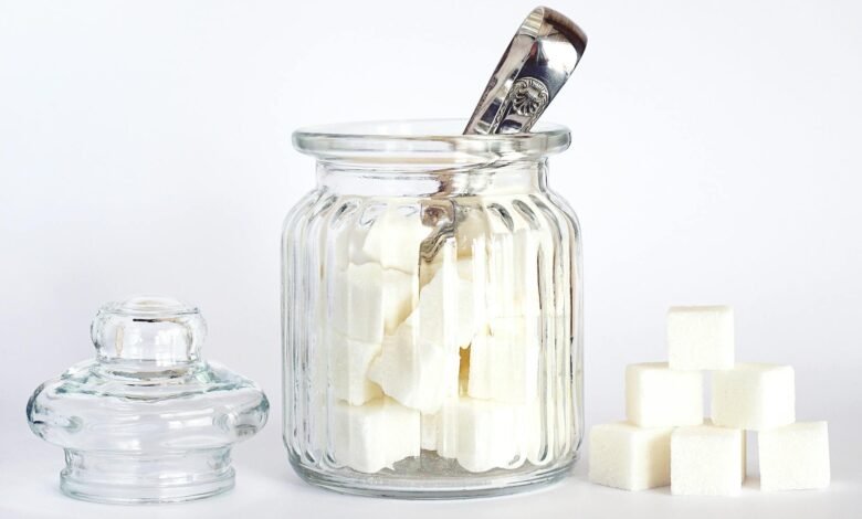 close up photo of sugar cubes in glass jar