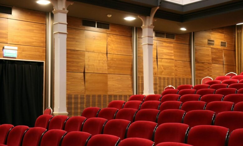 red theater chair lot near white concrete pillars