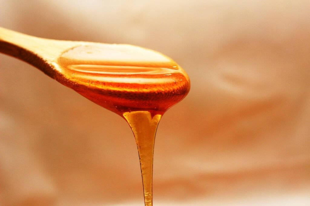 brown wooden spoon with honey