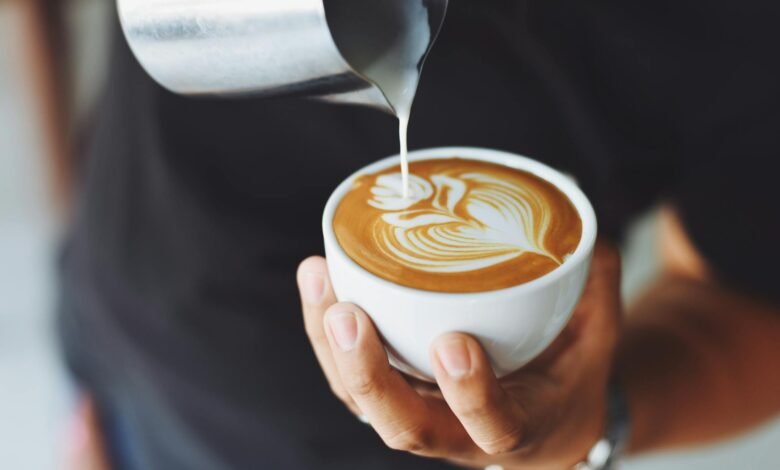 person performing coffee art