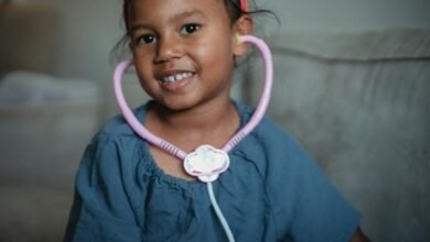 cheerful asian girl with stethoscope