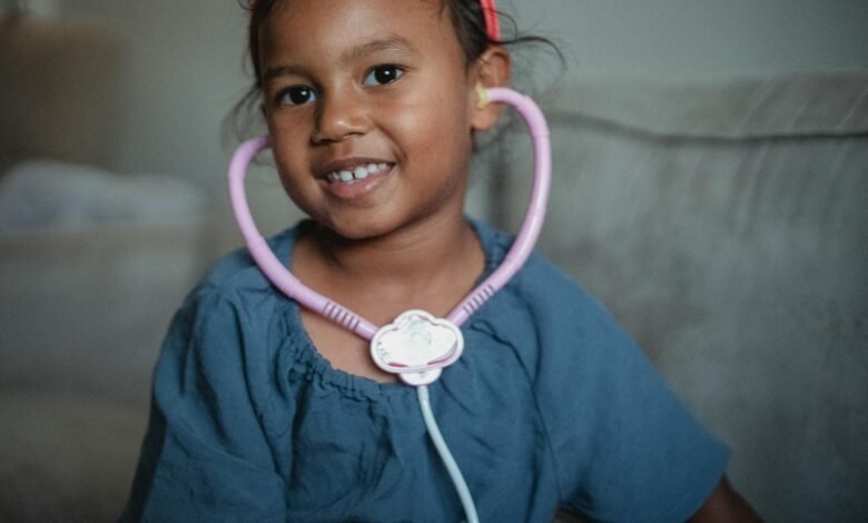 cheerful asian girl with stethoscope