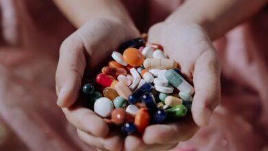 a handful of assorted medicines on a child s hands