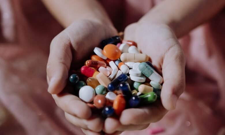 a handful of assorted medicines on a child s hands