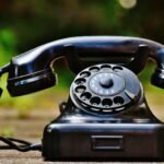 selective focus photography of black rotary phone