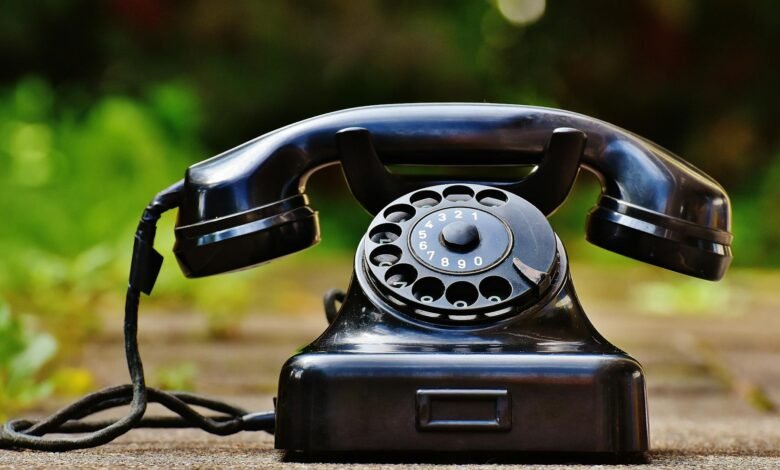 selective focus photography of black rotary phone