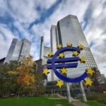 euro currency monument in front of bank buildings