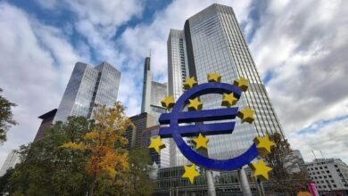 euro currency monument in front of bank buildings