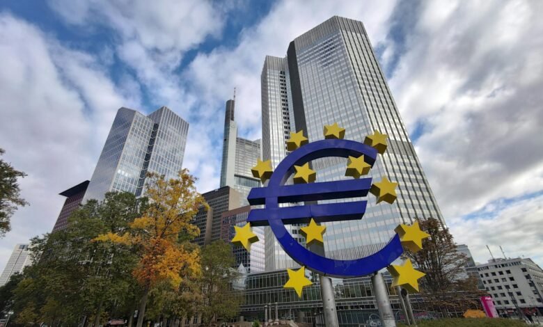 euro currency monument in front of bank buildings