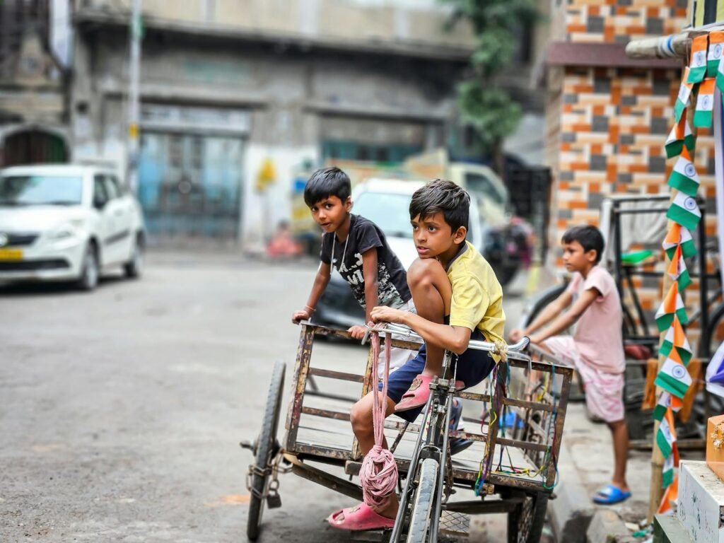 boys sitting on bike with trailer