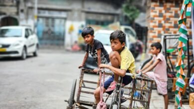 boys sitting on bike with trailer