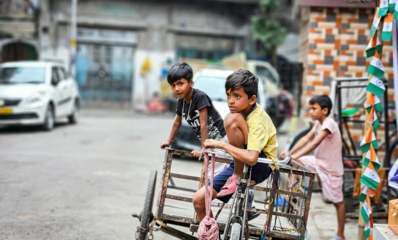 boys sitting on bike with trailer