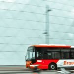 selective focus photography of red and white bus