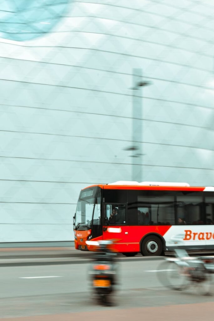 selective focus photography of red and white bus