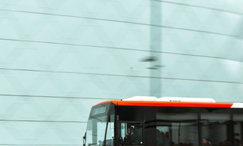 selective focus photography of red and white bus