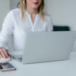 woman using silver laptop