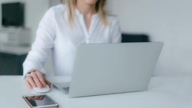 woman using silver laptop