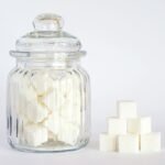 close up photo of sugar cubes in glass jar