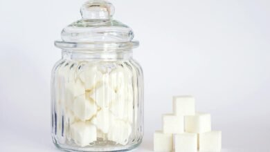 close up photo of sugar cubes in glass jar