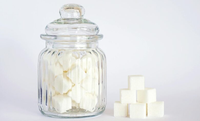 close up photo of sugar cubes in glass jar