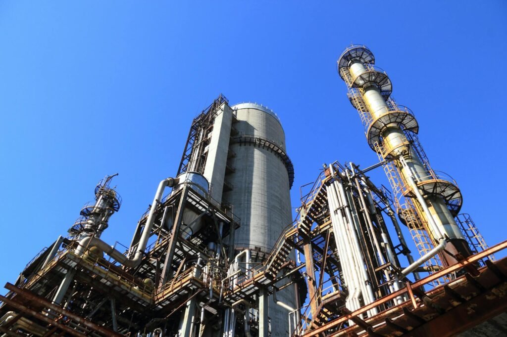 low angle shot of manufacturing plant under blue sky