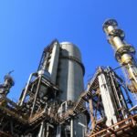 low angle shot of manufacturing plant under blue sky