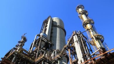 low angle shot of manufacturing plant under blue sky