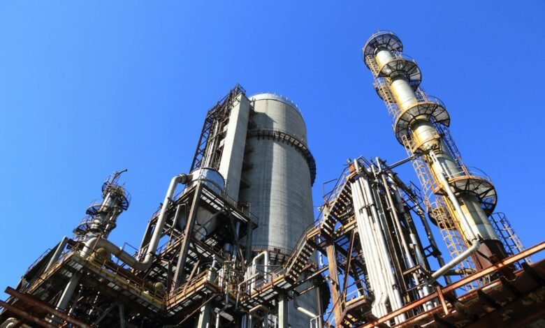 low angle shot of manufacturing plant under blue sky