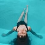 woman in black tank top in water