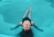 woman in black tank top in water