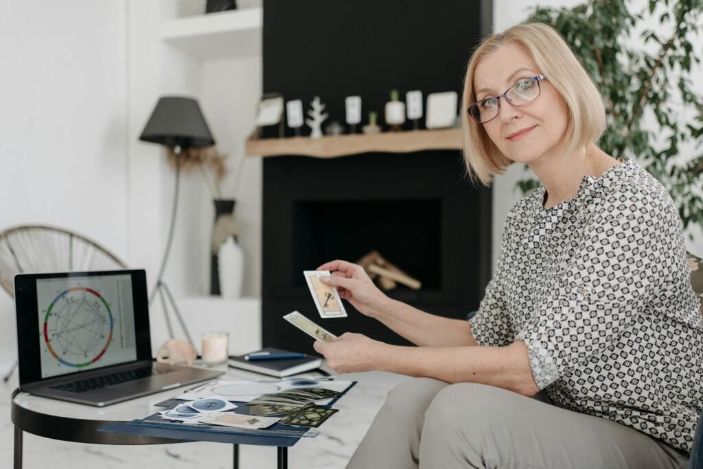 woman holding tarot cards in a living room