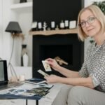 woman holding tarot cards in a living room