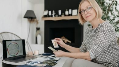 woman holding tarot cards in a living room