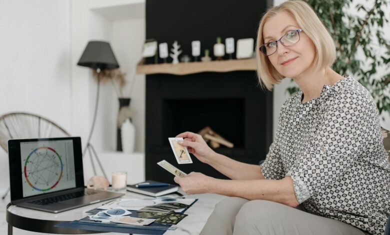 woman holding tarot cards in a living room