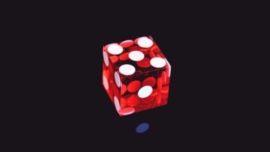 red translucent die on top of black surface