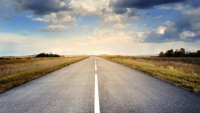 asphalt road under cloudy sky