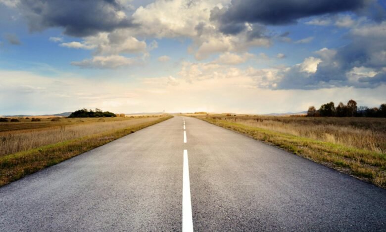 asphalt road under cloudy sky