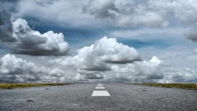 gray rolled asphalt road under cloudy sky
